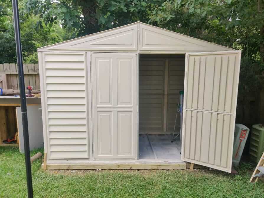 Duramax 10.5' x 5.0' Woodbridge with Foundation 00283 shed in yard with one door open